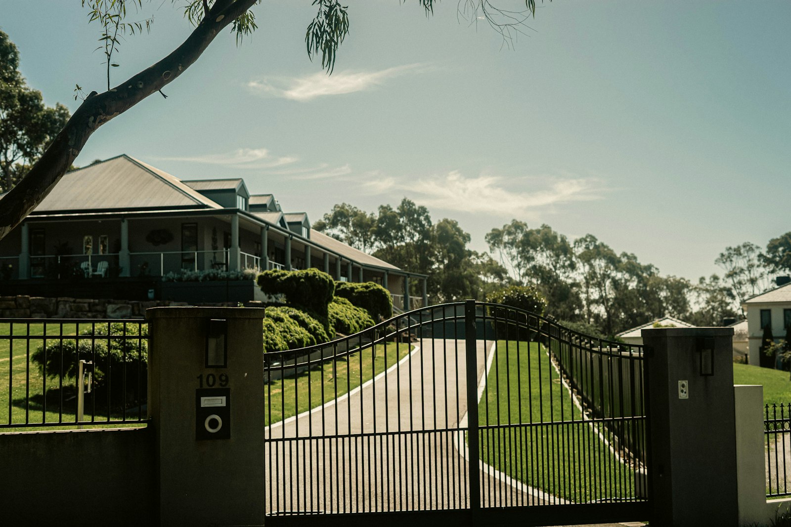 Automatic residential gate with intercom panel at entrance